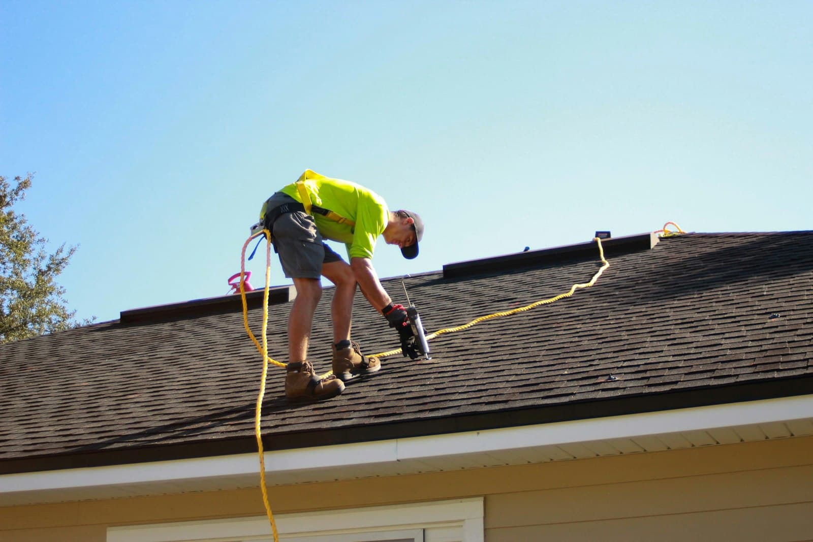Roofer using a power drill